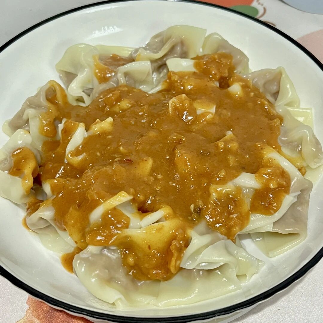 Wontons served with homemade satay sauce at the shop.jpg