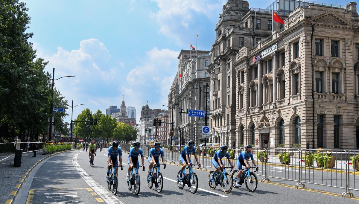 A parade of cyclists, featuring athletes representing all participating teams, rides along the iconic Bund, kicking off the event.jpeg