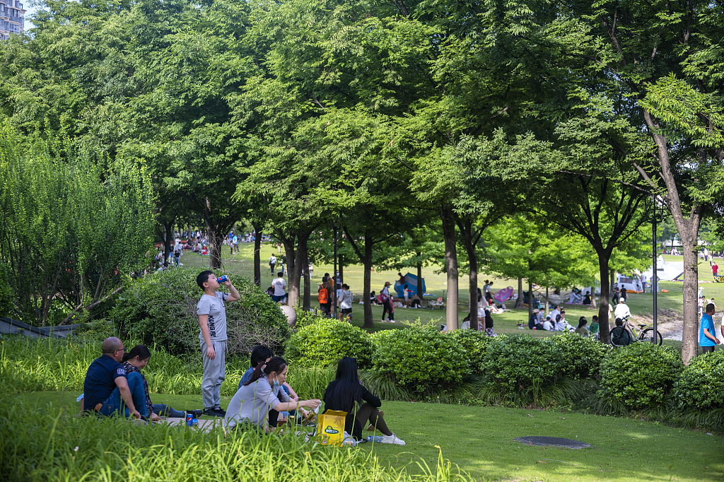 Residents cool off in a park in June. .jpg