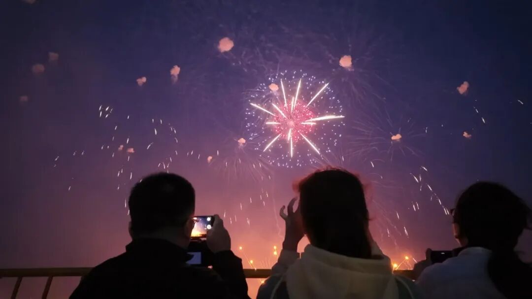 Visitors photograph fireworks illuminating the sky in Jinshan..jpg
