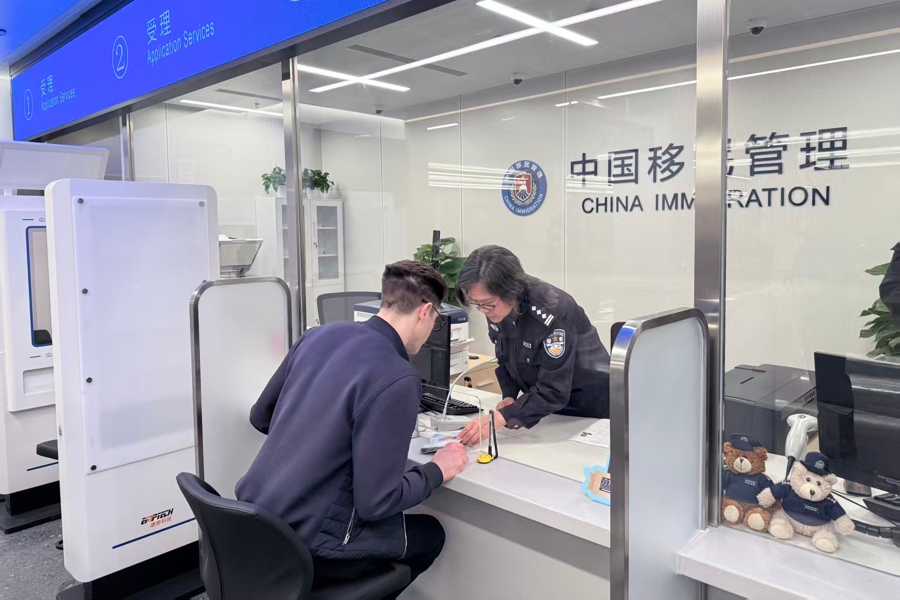 ​An immigration officer provides services to a business traveler.png