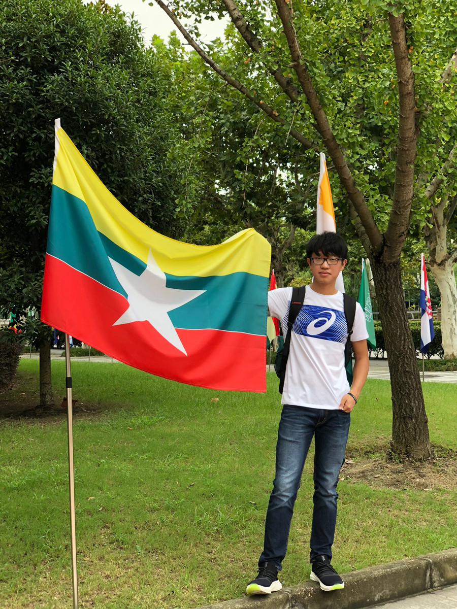 Aung Khaing Min poses with the national flag of Myanmar..jpg