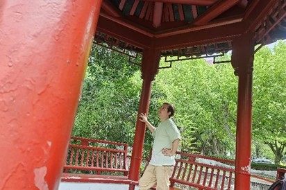 Cesar Ulises Gonzalez Flores  admires the architectural style of a pavilion. 