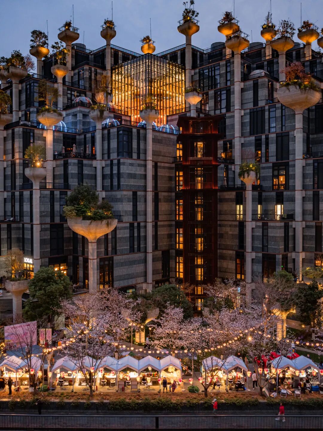 Market stalls line the waterfront near the Tian
