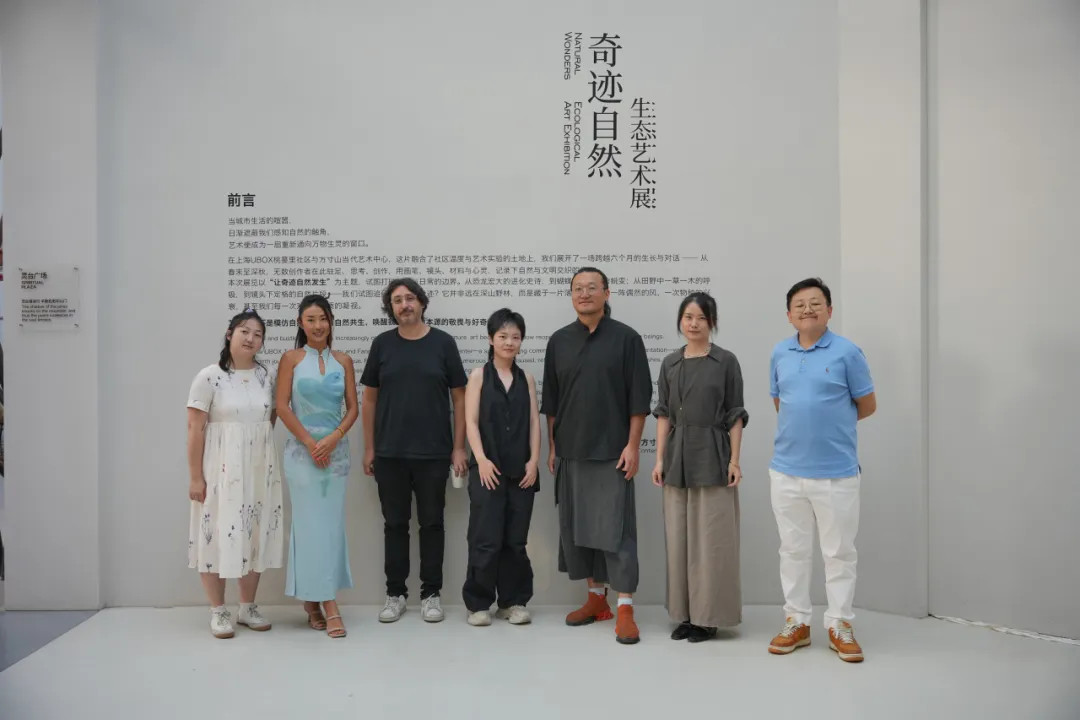 Artists and guests pose for a group photo at the exhibition.jpg