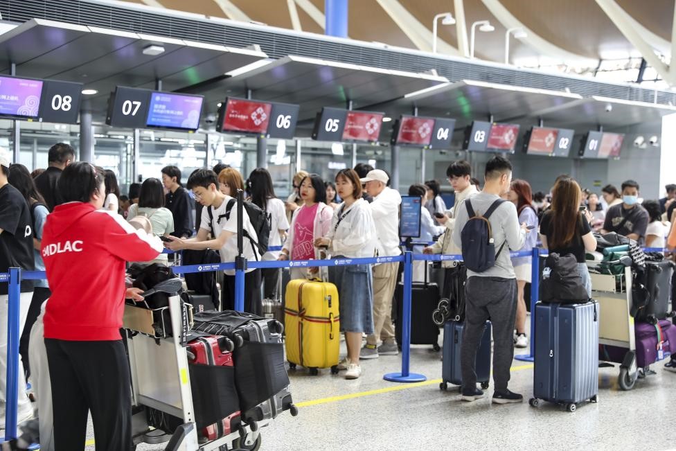 Passengers wait for check-in at Shanghai Pudong International Airport on May 1, 2025..jpg