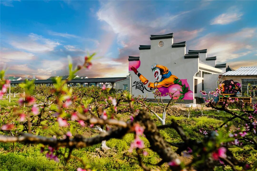 A mural featuring the Monkey King and peaches adorns a wall at Lyuxiang Fruit Park..jpg