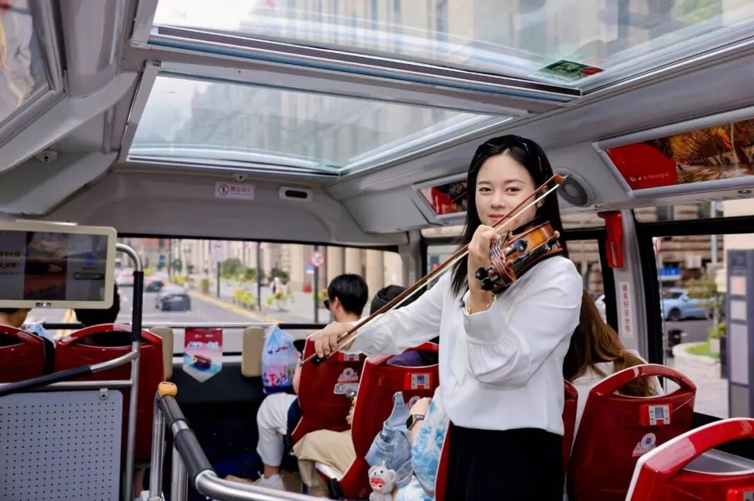 A violinist performs aboard the bus.jpg