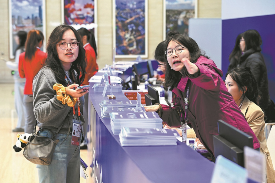 A staff member assists a journalist 1.png