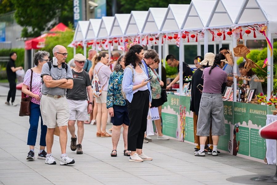 Visitors browse a market in Shanghai in September..jpg