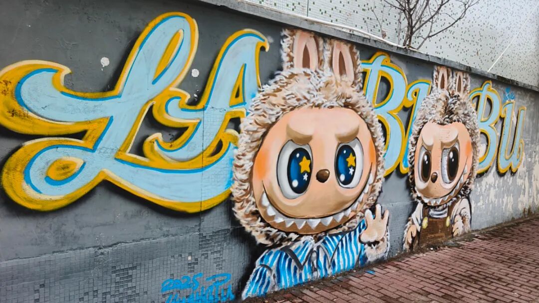 The riverside wall is adorned with graffiti featuring Labubu dolls.jpg