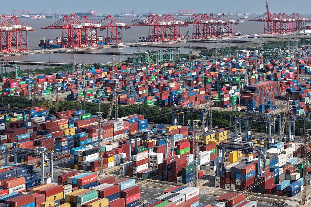 A bustling foreign trade container terminal with constant truck and vessel movements at Shanghai Port on Feb 14, 2026. PhotoVCG.jpg