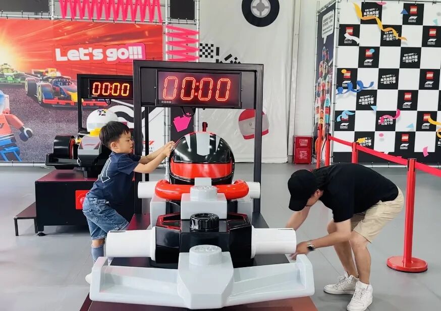 Families work together to change a Lego race tire.jpg