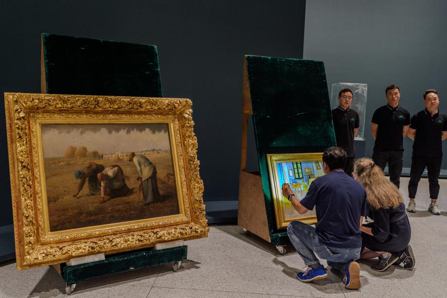 Staff members check the paintings..jpeg