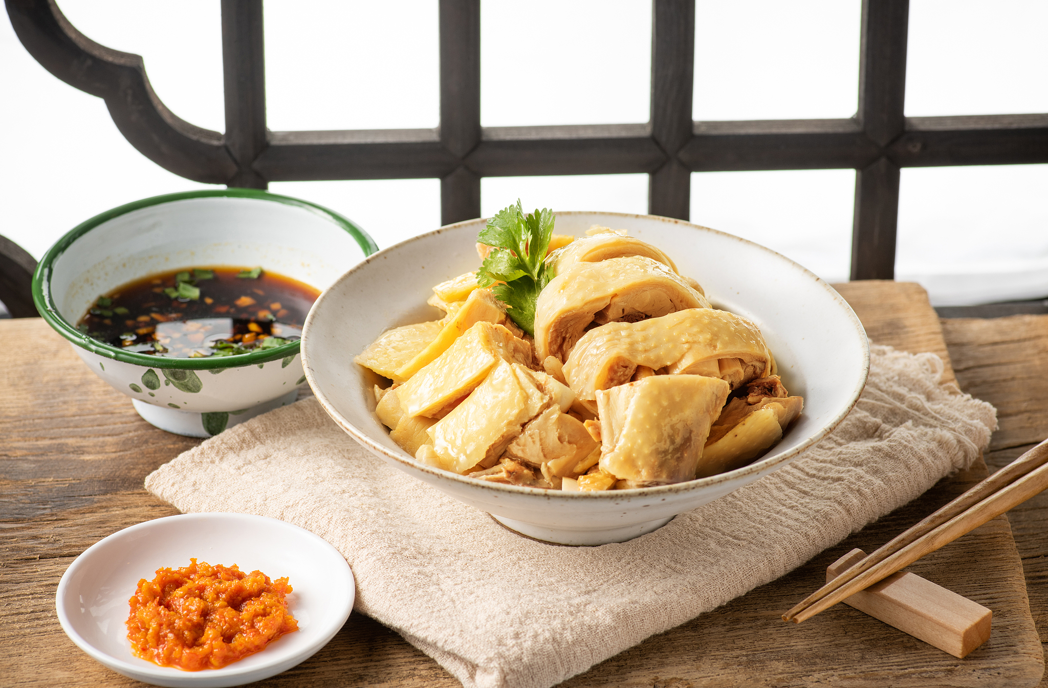 Tender poached chicken is served cold with dipping sauce.jpg