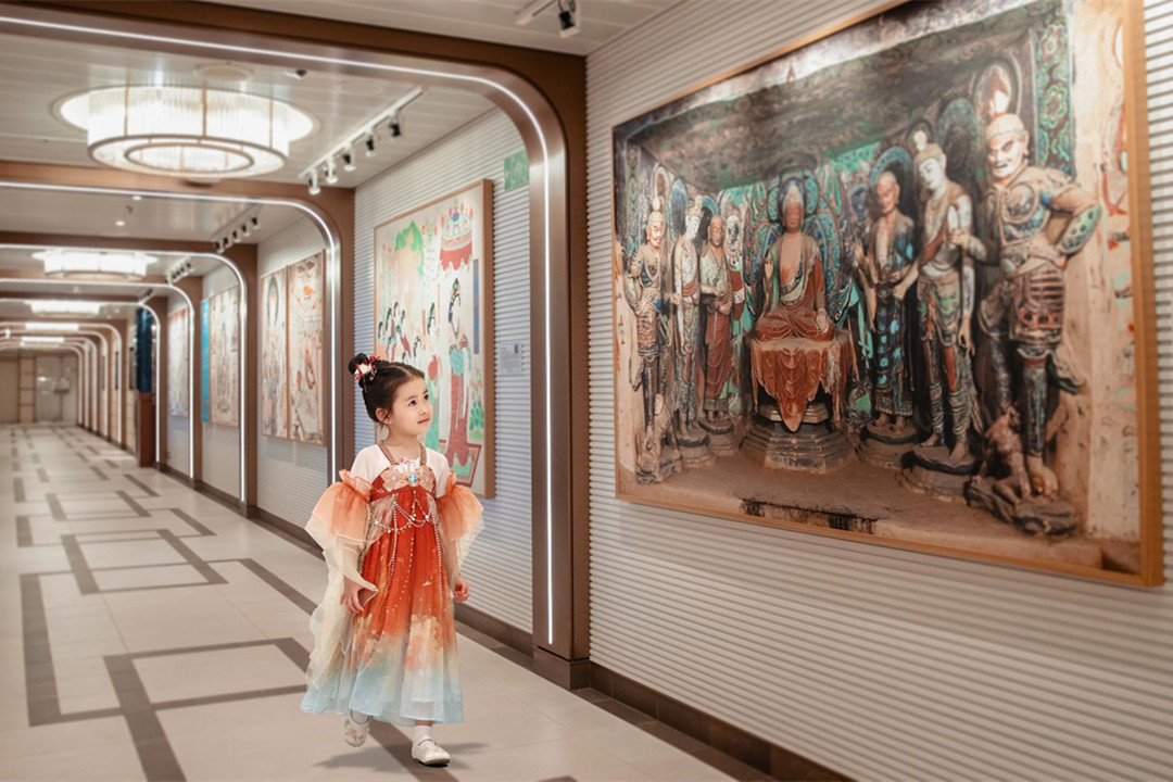 A child dressed in traditional Chinese attire visits the art gallery on the Adora Magic City.jpg