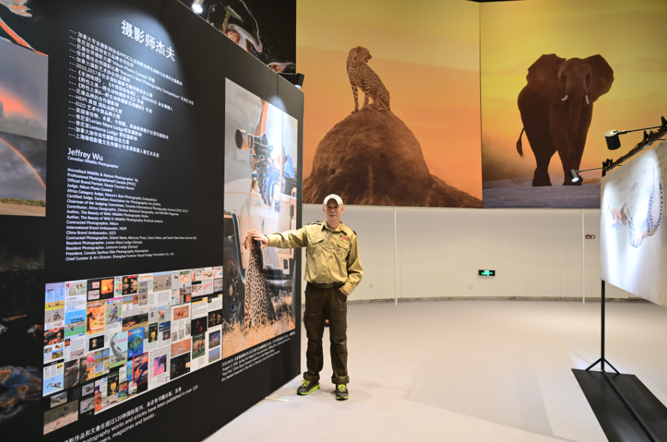 Jeffrey Wu poses for a photo with his exhibition.png