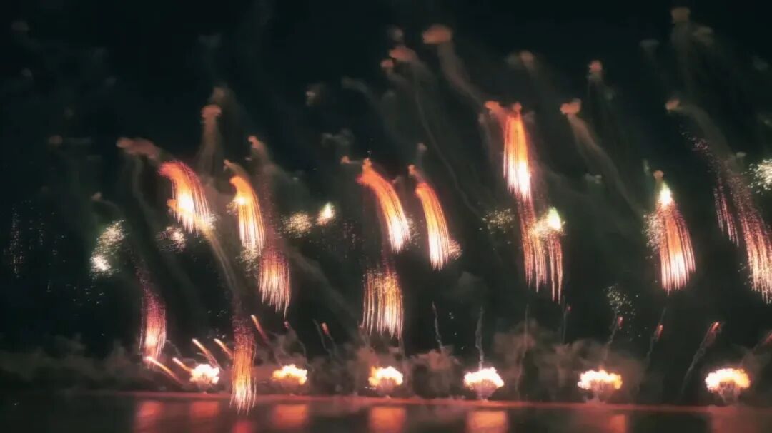 Brilliant fireworks burst over the water and cascade down like a waterfall..jpg
