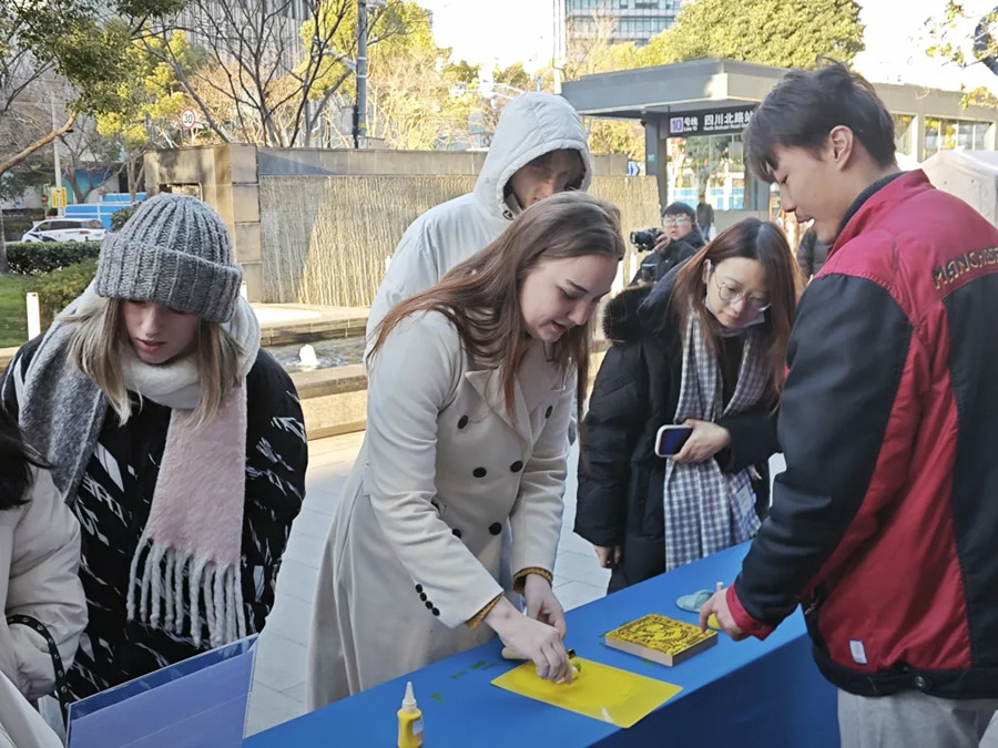 Students try their hand at stone rubbing.jpg